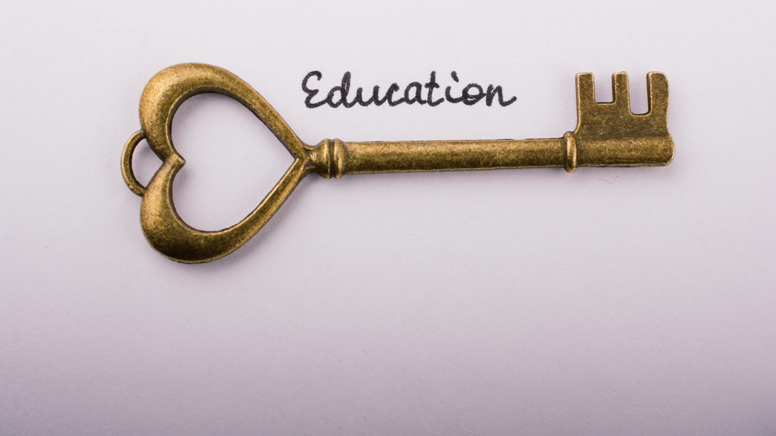 Image of a golden key with the word Education written above it in cursive.